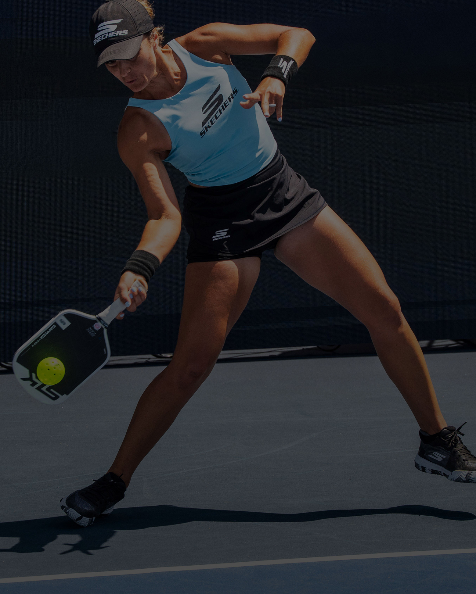 A woman playing pickleball